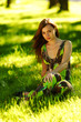 brunette sitting on green grass