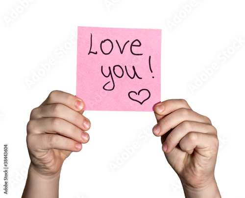 Photo: boy hand holding notepaper on white background boy hand holding notepaper on white background