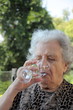 senior woman drinking water senior woman drinking water