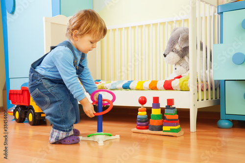 Photo: Boy playing with stacking rings Boy playing with stacking rings