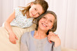 Grandmother with young girl smile relax together