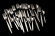 Forks and spoons on a black background