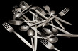 Forks and spoons on a black background