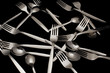 Forks and spoons on a black background