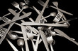 Forks, knives and spoons on a black background