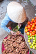Vietnamese woman selling ginger in a market, Ho chi minh city, V