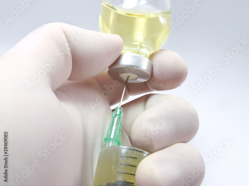 Photo: Hand, a syringe and vial Hand, a syringe and vial