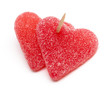 two heart-shaped candies atached to each other with a toothpick