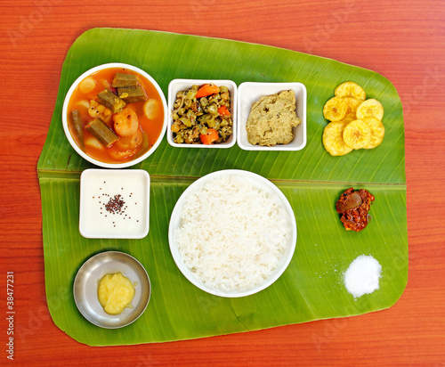 Photo: Traditional southern-indian meals on plantain leaf Traditional southern-indian meals on plantain leaf