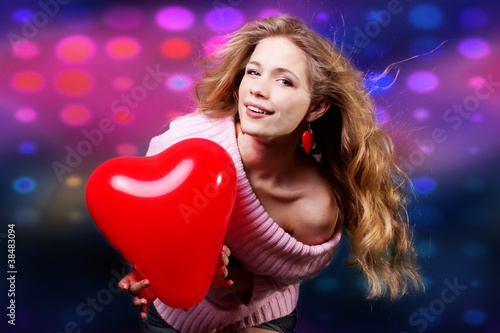 Photo: Valentines day woman holding red heart balloon Valentines day woman holding red heart balloon