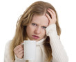young woman with the flu and headache with a mug of tea isolated