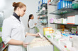 Pharmacy chemist women in drugstore