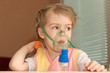 A little girl three years doing inhalation