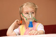 A little girl three years doing inhalation