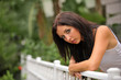 lovely brunette beside fence in key west garden