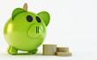 Illustration: green piggy bank with coins isolated on white green piggy bank with coins isolated on white