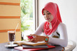 Young muslim stylish women writing text messaging