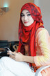 Young muslim stylish women writing text messaging