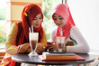Beautiful muslim woman sharing reading information on mobile pho