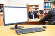 Photo: Office computer on desk and two businesspersons defocused Office computer on desk and two businesspersons defocused