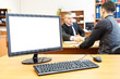 Photo: Office pc and two businesspersons on background handshaking Office pc and two businesspersons on background handshaking