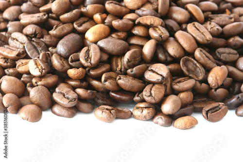 Photo: Whole coffee beans scattered on white background Whole coffee beans scattered on white background