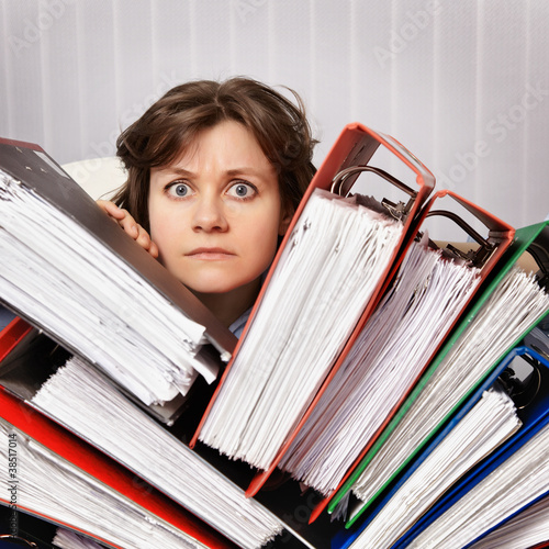Photo: Accountant swamped with financial documents Accountant swamped with financial documents