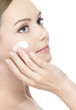 Beautiful woman with cream on face