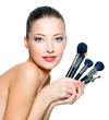 Beautiful woman with make-up brushes