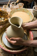 hands of a potter, creating an earthen jar of white clay hands of a potter, creating an earthen jar of white clay