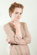 Stern looking redhead woman in studio