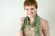 Portrait of smiling red haired woman wearing a scarf