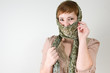 Red haired woman playing with scarf