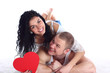 Happy young adult couple with red heart lie on the floor Happy young adult couple with red heart lie on the floor