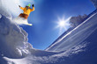 Snowboarder jumping against blue sky