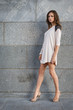 Young woman against a stone wall
