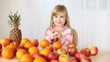 Child drinking orange juice at the table Child drinking orange juice at the table
