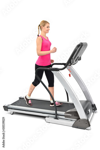 Photo: young woman doing exercises on treadmill young woman doing exercises on treadmill