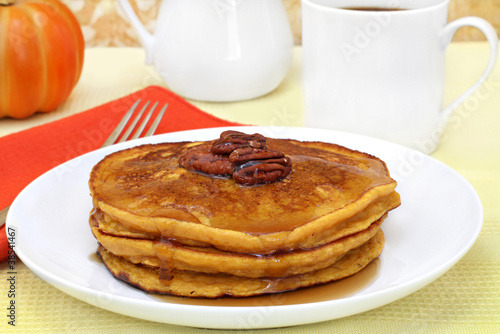 Photo: Pumpkin pancakes with pecans and syrup. Pumpkin pancakes with pecans and syrup.