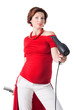 Photo: young pregnant woman styling your hair with hairdryer young pregnant woman styling your hair with hairdryer