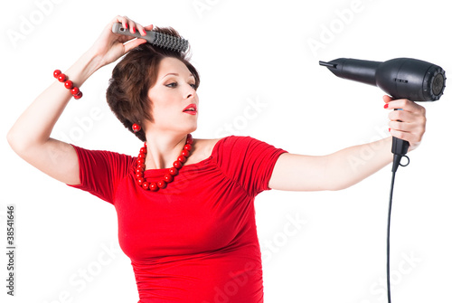 Photo: young pregnant woman styling your hair with hairdryer young pregnant woman styling your hair with hairdryer
