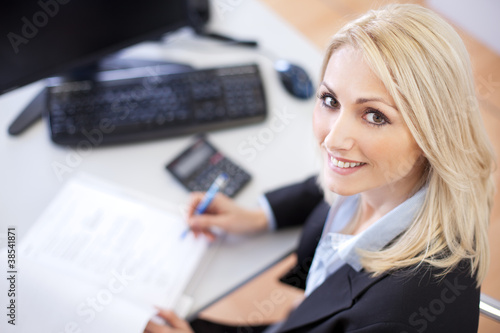 Photo: Beautiful businesswoman doing finances Beautiful businesswoman doing finances