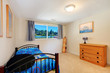 Kids boy bedroom with blue bed and dresser.