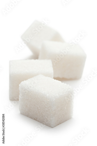 Photo: Cubes of sugar on the white background Cubes of sugar on the white background