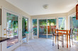 Dining room with lots of windows and small dining table