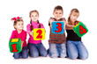 Happy kids holding blocks with numbers