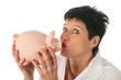 Young woman kissing piggy bank