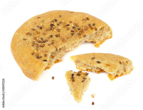 Photo: Pieces of Homemade Bun with Sesame Seeds Isolated on White Pieces of Homemade Bun with Sesame Seeds Isolated on White