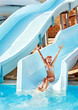 Child on water slide at aquapark.