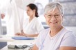 Senior woman smiling at doctor's room